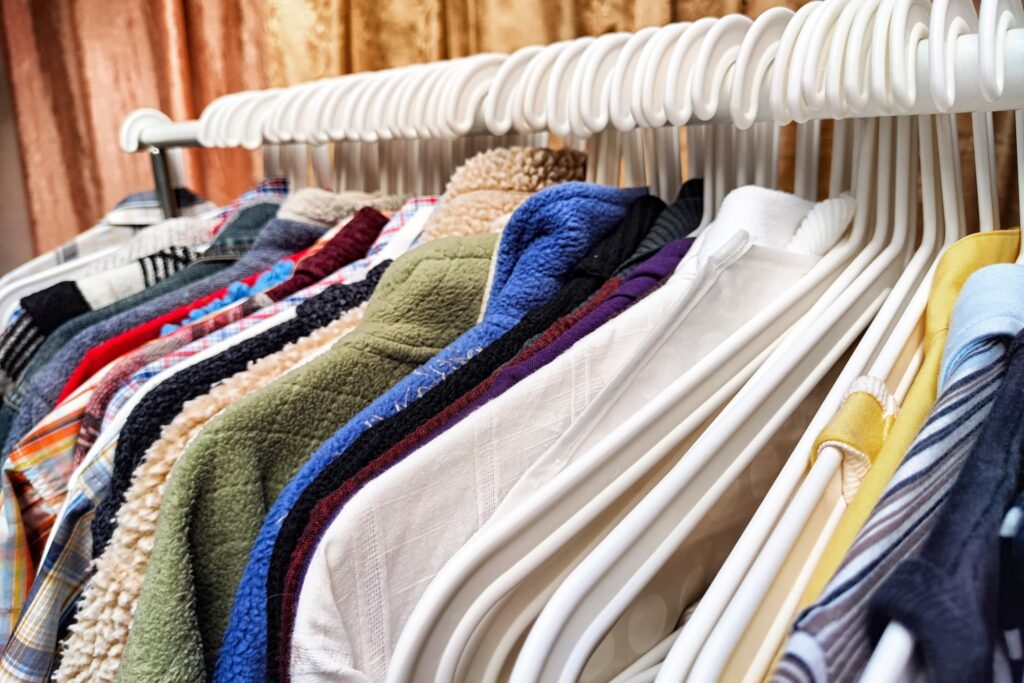 A closeup of clothes on hangers