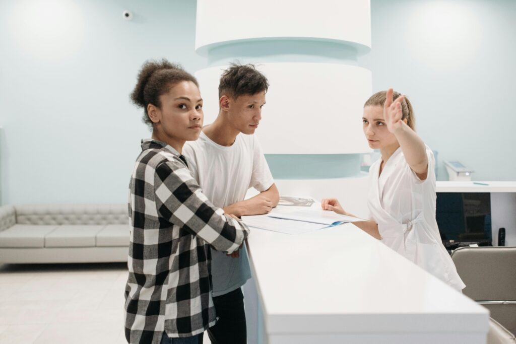A couple is at the nurses' station in a health centre