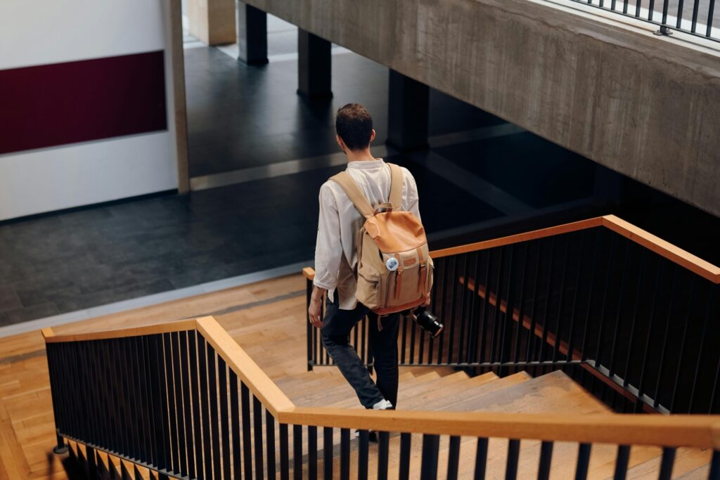 Male student walking down the school's staircase