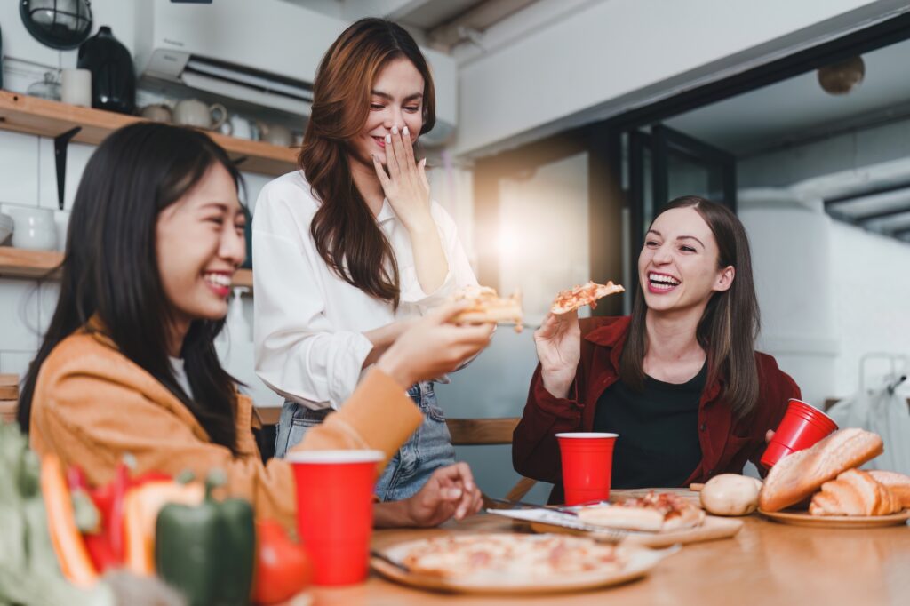Friends celebrating a birthday in their shared flat